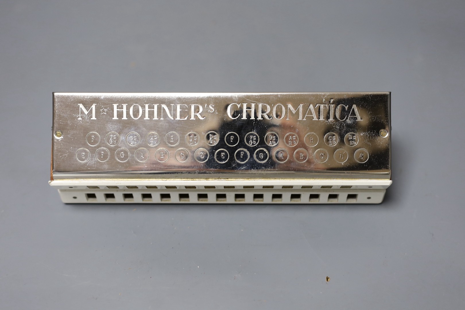 Three cased Hohner harmonicas including a chronomatica no.265